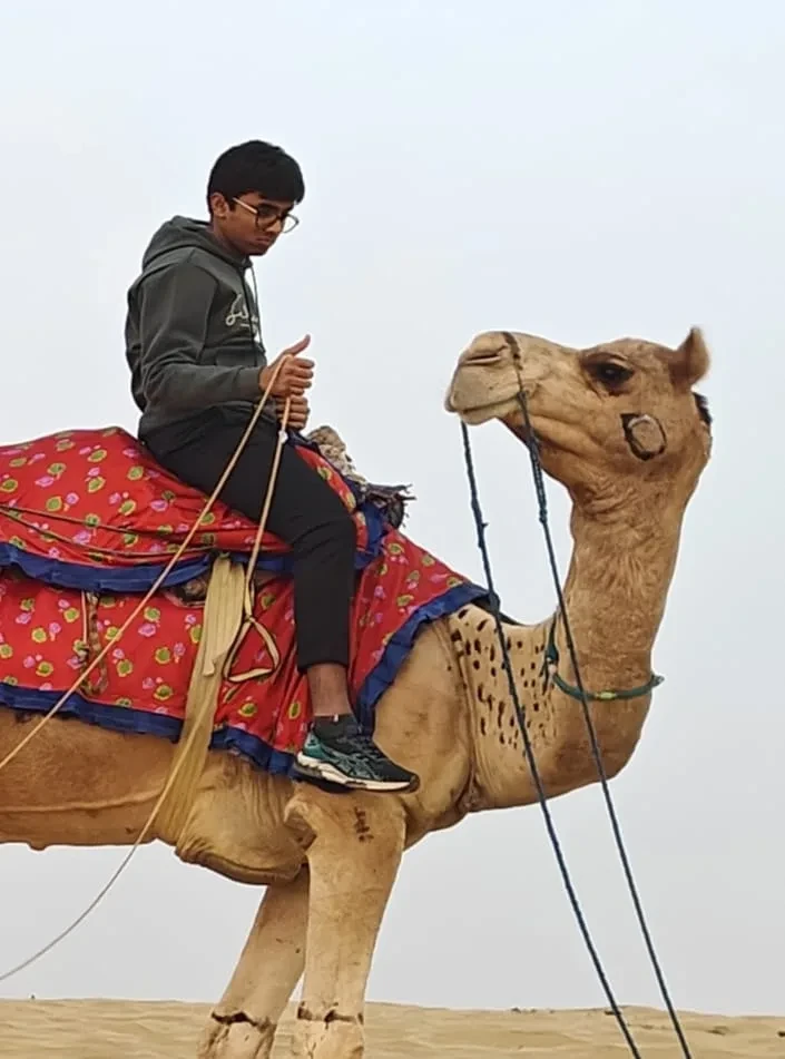 Riding a camel on sand dunes