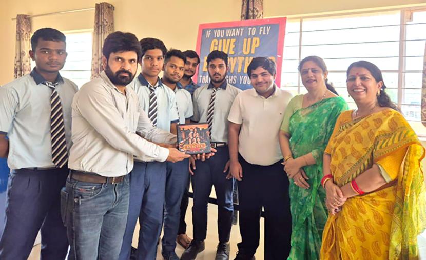 A team member distributing TaxCity kits for free at a government school in Rajasthan
